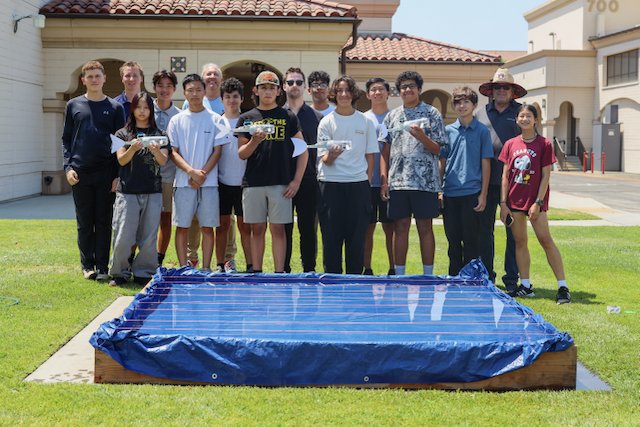 Students proudly display their bionic fish before the big race